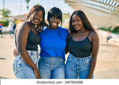 Three African American Friends Smiling Happy Hugging At The City.