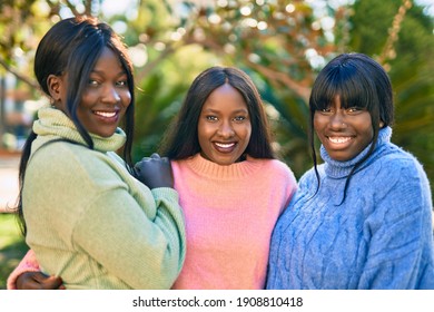 Three African American Friends Smiling Happy Hugging At The Park.