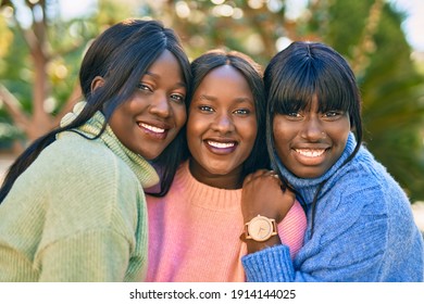 Three African American Friends Smiling Happy Hugging At The Park.