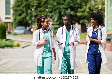Three African American group doctors with stethoscope wearing lab coat.