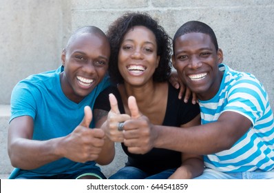 Three African American Men And Woman Showing Thumb