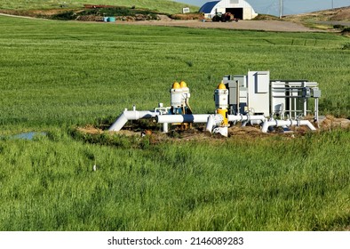 Three agricultural water pumps at a pumping station to bring water up from a well for irrigation in an Idaho Farm field.