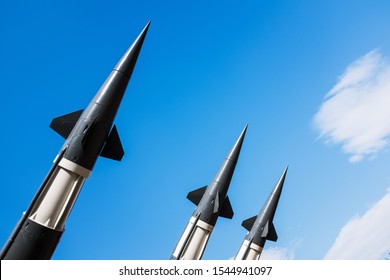 Three anti aircraft air force missiles, defensive weapon system heads, against a bright blue sky with few white clouds, 4th of July memorial day celebration, patriotism and remembrance, Russia Ukraine