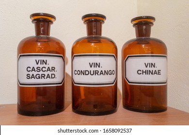Three antique empty bottles for homeopathic natural medicine with the academic name on the label: VIN. Cascar Sagrad, VIN. Condurango and VIN. Chinae