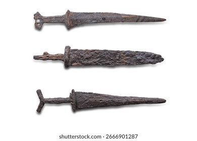 Three antique objects in a line against a gray backdrop Includes an aged key, possibly a spike or nail, and two similar, rusted metal items Display style suggests historical artifacts with an empha