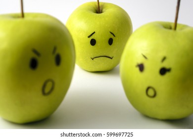 Three Apples With Drawn Faces Representing Sad Child Seeing Parents' Fight