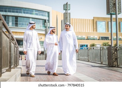 Three arabic men bonding outdoors - Businesspeople walking and talking in Dubai