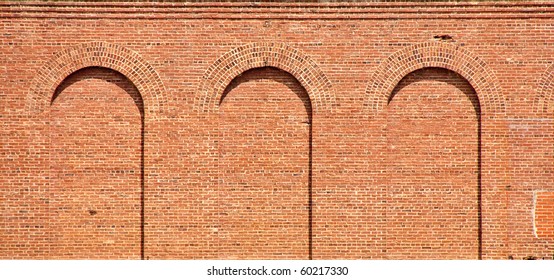 Three arches in an old brick wall