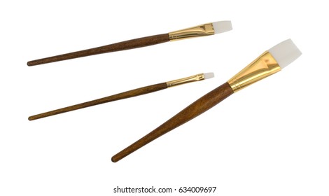 Three Artist Paintbrushes Isolated On A White Background.