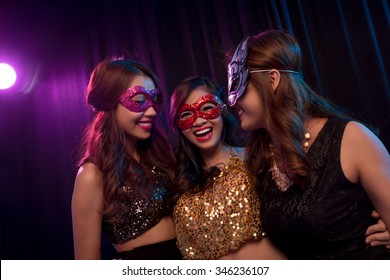 Three Asian Girl In Masquerade Masks Having Fun In Night Club