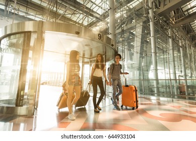 Three Asian Traveler Friends Entering Airport With Happy Face