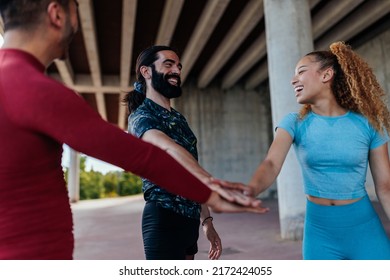 Three Athletes Are In A Team Huddle Before Working Out Together