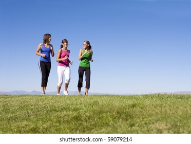 Three Attractive Women Jogging Outdoors Together