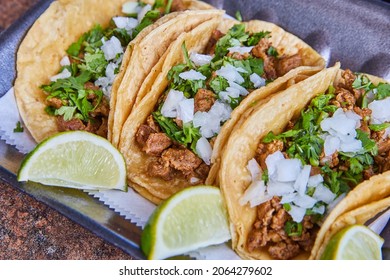 Three authentic Mexican taco steak with onions, cilantro, and lime