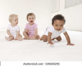 Three Babies Laughing And Crawling On Floor