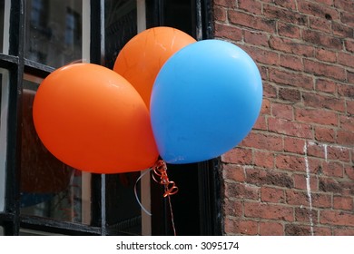 three balloons hanging outside window