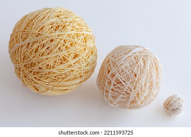 Three Balls Of Yarn Of Different Sizes Isolated On White Background