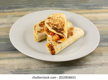 Three BBQ Chicken Pineapple Quesadillas Meal On White Dinner Plate On Table