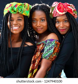Three beautiful African models  wearing traditional headdresses posing for the camera