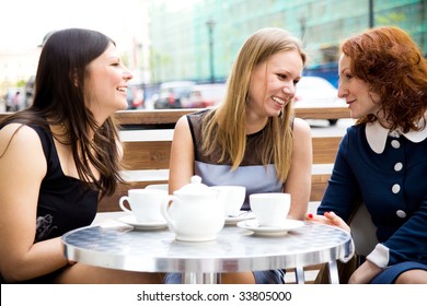 Three Beautiful Women Drinking Coffee Outdoors