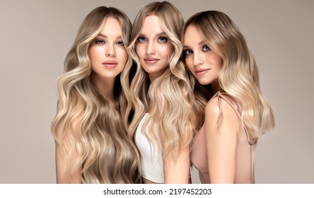 Three beautiful women with hair coloring in ultra blond. Stylish hairstyle curls done in a beauty salon. Fashion girls , cosmetics and makeup. - Shutterstock ID 2197452203