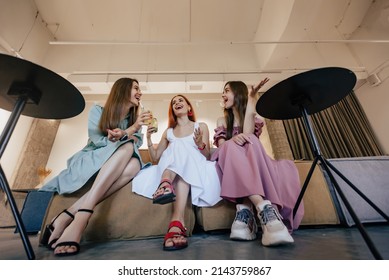 Three Beautiful Women Triplets Talking And Drinking Cocktails In Restaurant