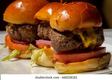 Three Beef Cheeseburger Sliders In A Row