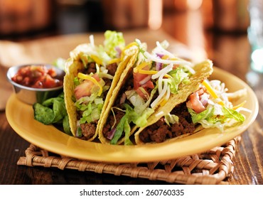 Three Beef Mexican Tacos With Cheese And Lettuce