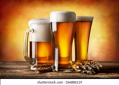 Three Beers And Wheat On A Yellow Background