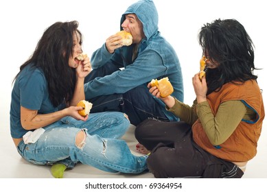 Three beggars sitting , sharing a bread and eating together
