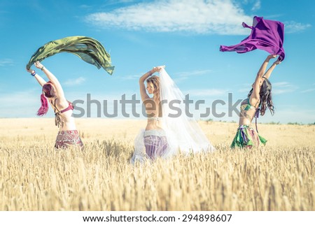 three belly dancer in the wheat. concept about arabic dancing and people
