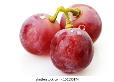 Three Berries Of Red  Grapes Close Up. It Is Isolated On A White Background