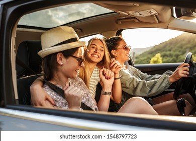 Three best female friends travel together.They drives a car and making fun.Summer adventure