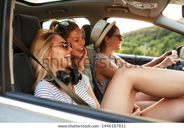 Three best female friends travel\
together.They drives a car and making fun.Summer\
vacation.