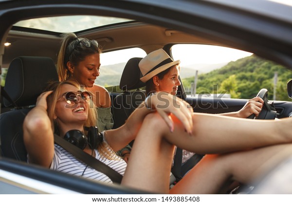 Three best female friends travel\
together.They drives a car and making fun.Summer\
adventure..