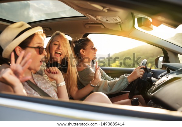 Three best female friends travel\
together.They drives a car and making fun.Summer\
adventure..