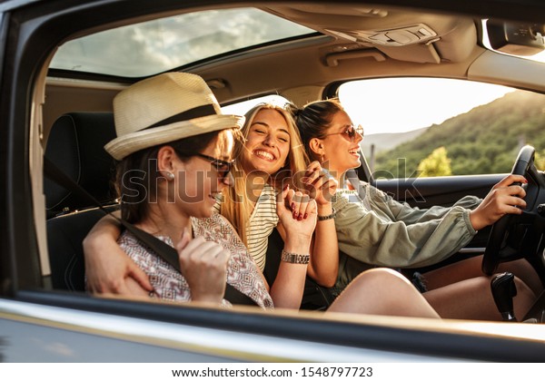 Three best female friends travel\
together.They drives a car and making fun.Summer\
adventure