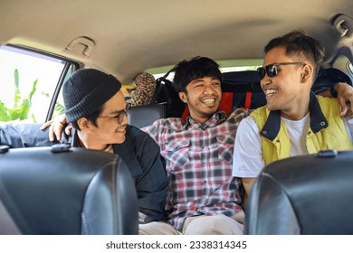 Three best male friends travel together. Sitting in a backseat car and having fun. Summer adventure concept. - Powered by Shutterstock