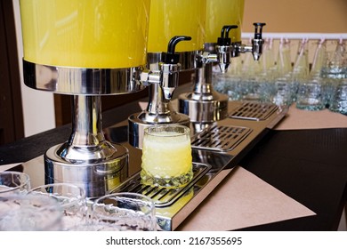 Three Beverage Dispensers With Lemonade Standing On The Table. Refreshment Drinks. Self Serving Device. Help Yourself With Drinks. Non-alcoholic Beverages.