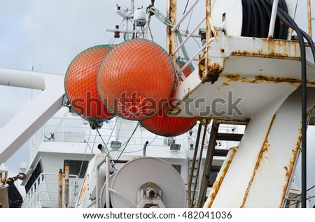 three big float on big fishingboat mark where the net is in the sea
