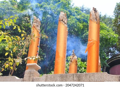 Three big incense sticks are burning and smoking, in front of the A-ma temple, Macao, May 14, 2017 