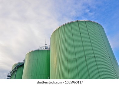 Three biogas tanks on a biogas plant. Wastes recycling ecology concept. Green economics. Copy space.