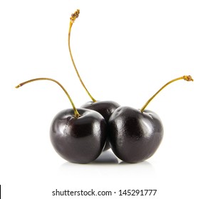 Three Black Cherries Isolated On A White Background