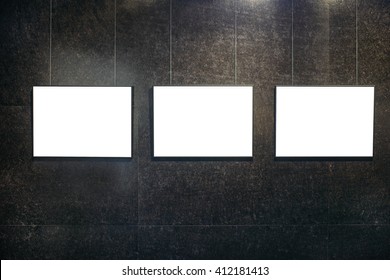 Three Black Picture Frames On Black Textured Wall.
