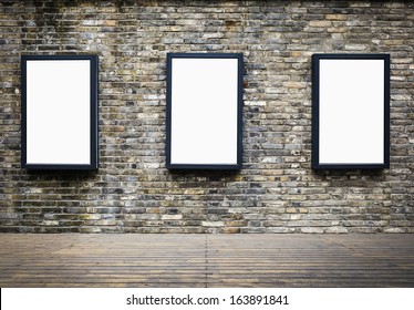 Three Blank Billboards Attached To A Building Exterior Old Brick Wall