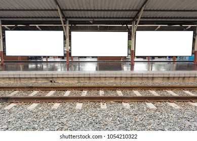 Three Blank Billboards On Railway Station Platform With Railroad Foreground. 