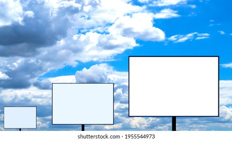 Three Blank Billboards Stand In A Row Against A Cloudy Sky.