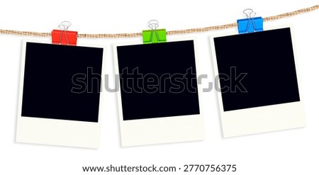 Three blank instant photo frames hanging on a jute rope with col