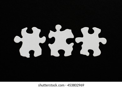Three blank puzzle pieces inline unlinked on black background