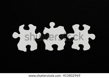 Three blank puzzle pieces inline unlinked on black background